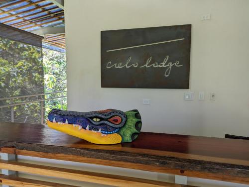 a colorful shoe sitting on top of a wooden bench at Cielo Lodge in Golfito