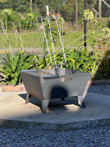 a metal wheelbarrow sitting on the ground at Come live the Keike experience! in Canela