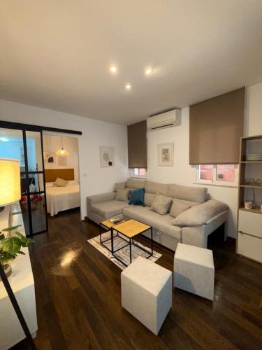 een woonkamer met een bank en een tafel bij Apartamento Azonaicas in Córdoba