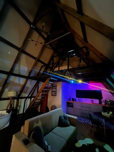 a living room with a couch and a stage at Come live the Keike experience! in Canela