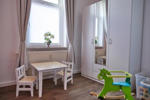 a small childs room with a table and chairs at City-Apartment 1 in Bernburg
