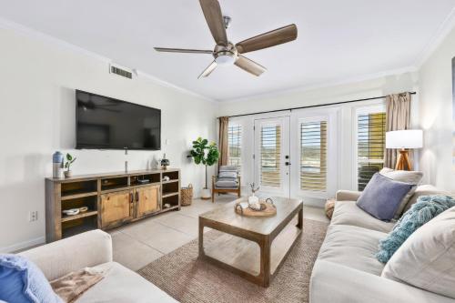 a living room with a couch and a flat screen tv at Island Summer Sunrises Spa Eats Last Minute Deals! in Lago Vista