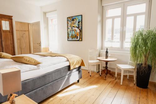 a bedroom with a bed and a table and chairs at St Jakobshof für Moselurlaub mit Familie in Ediger-Eller