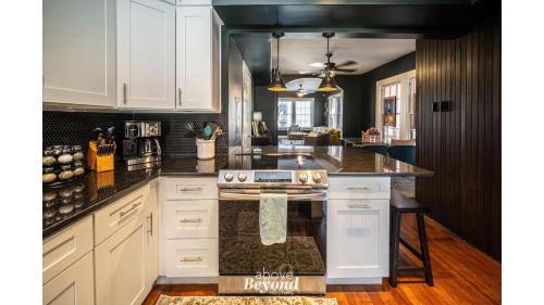 a kitchen with white cabinets and a stove top oven at The Royal Treatment Downtown, Great for Travels in San Antonio
