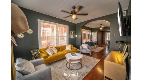 a living room with a yellow couch and a table at The Royal Treatment Downtown, Great for Travels in San Antonio