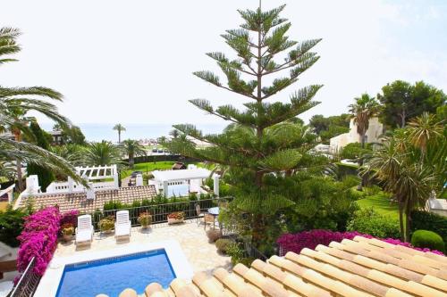 a view of a resort with a swimming pool and a tree at Casa BOWA in Hospitalet de l'Infant