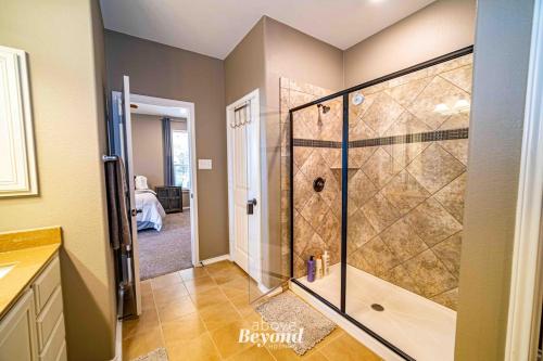 a bathroom with a shower with a glass shower stall at Steampunk Science in Round Rock