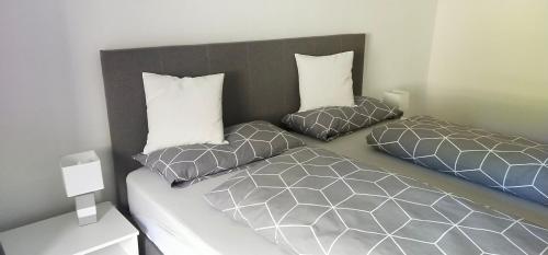 a bedroom with two beds with pillows on it at Ferienwohnung zur Kirschblüte in Schönberg
