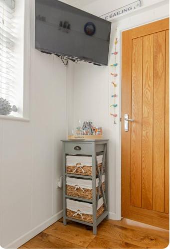 a room with a door and a shelf with bread at The Slopes in Whitstable