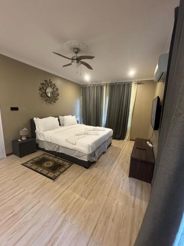 a bedroom with a bed and a ceiling fan at Meanwood Place Apartments in Lusaka