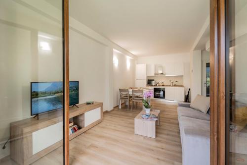 a living room with a couch and a flat screen tv at Como home residence in Carlazzo