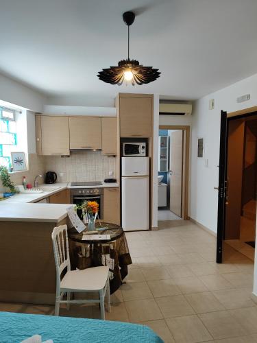 a kitchen with a table and chairs in a kitchen at Δροσια 1 in Nafplio