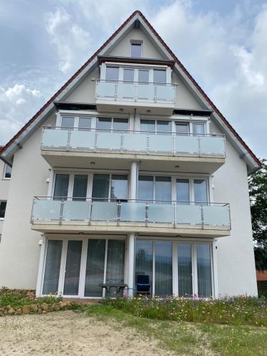 a white house with large windows and a balcony at Suite 32 in Oerlinghausen