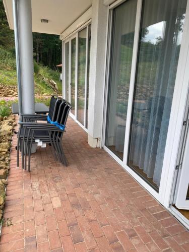 two chairs sitting on the porch of a house at Suite 32 in Oerlinghausen