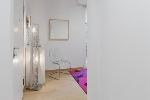 a room with a chair and a purple rug at Residence i Tigli in Cinisello Balsamo