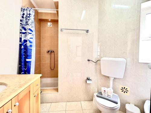 a bathroom with a toilet and a shower at Vilamoura Classic 2 with Pool by Homing in Quarteira