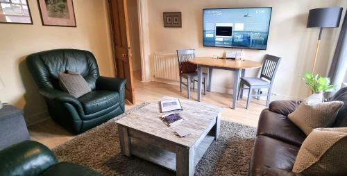 a living room with a couch and chairs and a table at 131 on Atholl in Pitlochry