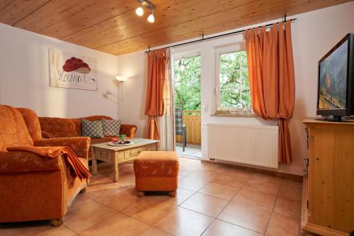 a living room with a couch and a table at Ferienhof Wuchner - Fewo "Herbstlaub" in Fröhnd