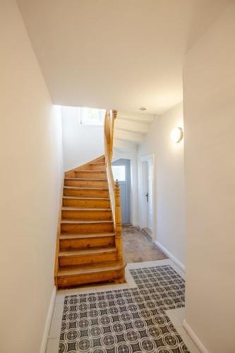 a stairway with a wooden staircase in a house at Apartment No2 in Stralsund