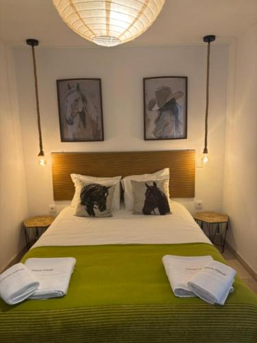 a bedroom with a large bed with two cats on it at Casa Lusitano by Valada Village in Valada