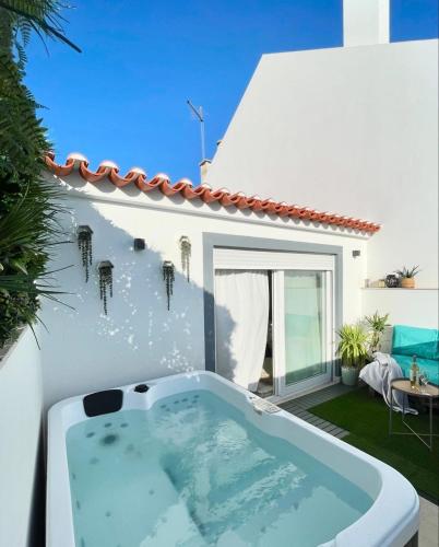 a bath tub in the backyard of a house at Casa Lusitano by Valada Village in Valada