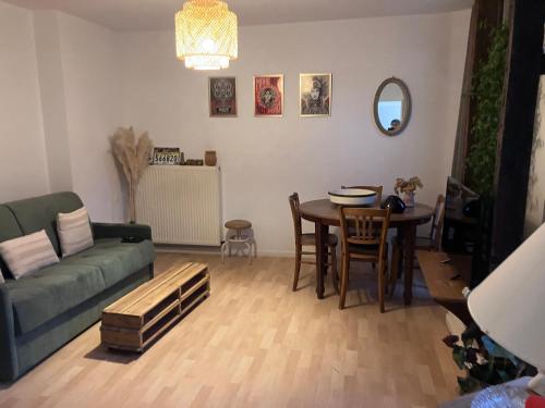 un salon avec un canapé et une table dans l'établissement Charmante maisonnette, à Troyes