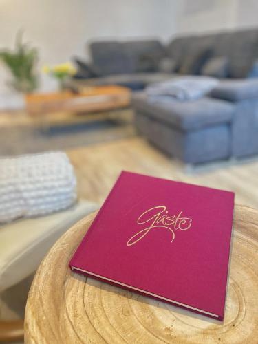 a purple book sitting on a table in a living room at Wohnung 3 Am Schlosspark in Bad Harzburg