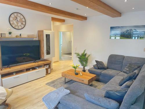 a living room with a couch and a large television at Wohnung 3 Am Schlosspark in Bad Harzburg