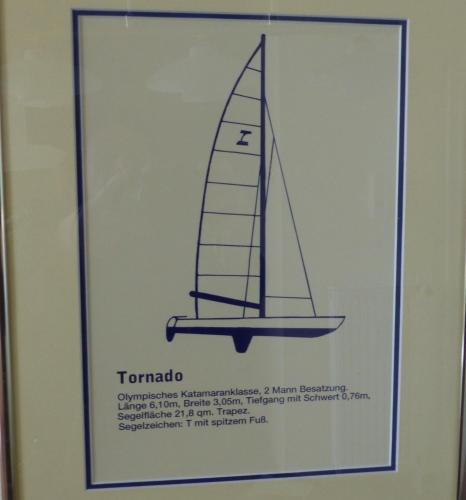 a sign for a sailboat on a wall at Tornado in Laboe