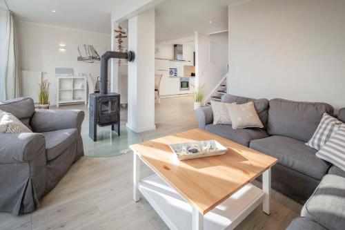 a living room with a couch and a wood stove at Beach 4 in Rettin