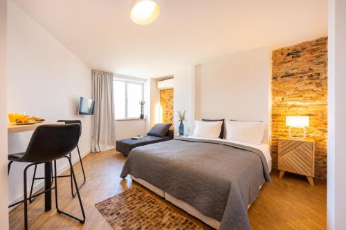 a bedroom with a bed and a desk with a chair at Apartment Musala N 01 in Varna City