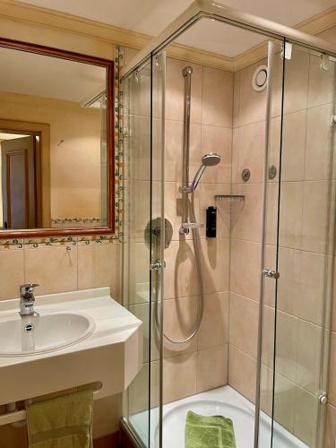 a bathroom with a shower and a sink at Schwarzwaldhotel Klumpp in Baiersbronn