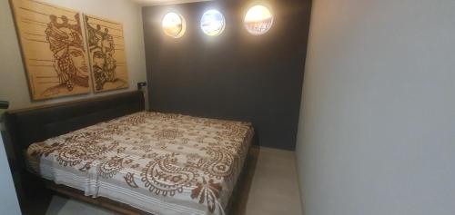 a bedroom with a bed and two lights on the wall at Kastaniennest in Bingerbrück