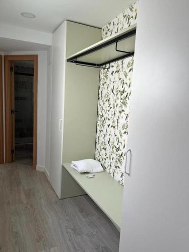 a room with a wall with a shelf and a window at Chloe Apartments TRG in Benidorm