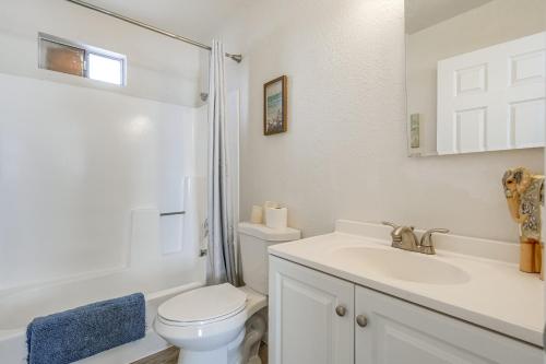 a white bathroom with a toilet and a sink at 2 Mi to Dtwn and Chase Field Condo with City View! in Phoenix