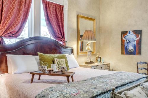 a bedroom with a bed with a table on it at The Gallery House Boutique Hotel in Stephenville