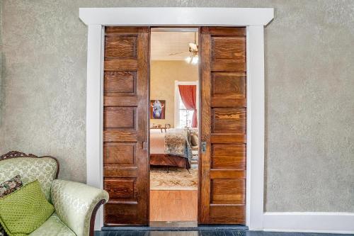 a door leading into a bedroom with a bed at The Gallery House Boutique Hotel in Stephenville