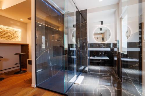a glass shower in a bathroom with a sink at 1823 Room in Chioggia