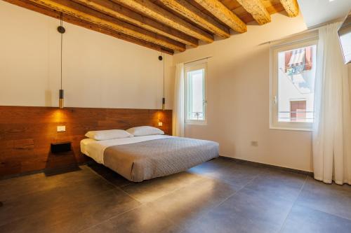 a bedroom with a large bed and a window at 1823 Room in Chioggia