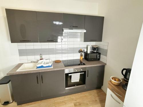 a kitchen with a sink and a counter top at Charme Médiéval à Provins in Provins