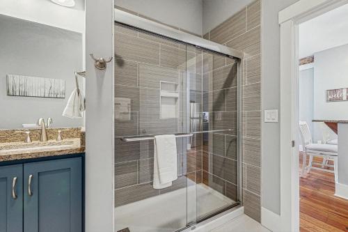 a bathroom with a shower with a glass door at Eagle Claw Den in Waynesville
