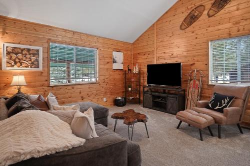 a living room with a couch and a flat screen tv at Basecamp in La Pine