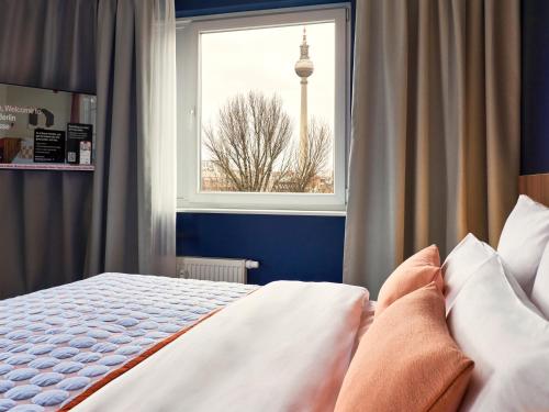 Postel nebo postele na pokoji v ubytování Numa Berlin Torstrasse