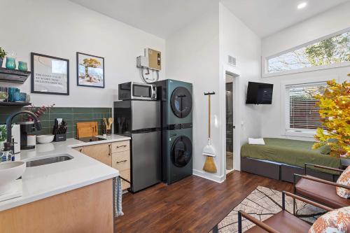 a kitchen with a sink and a refrigerator at The Acorn - Tiny House in HISTORIC OAKWOOD in Raleigh