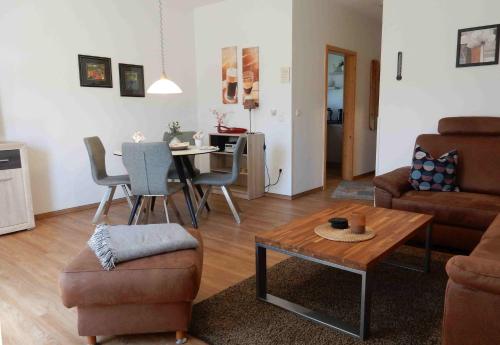 a living room with a couch and a table at Hinter den Dünen D82 in Prerow