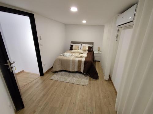 a bedroom with a bed in a white room at Casa de São Miguel in Mirandela