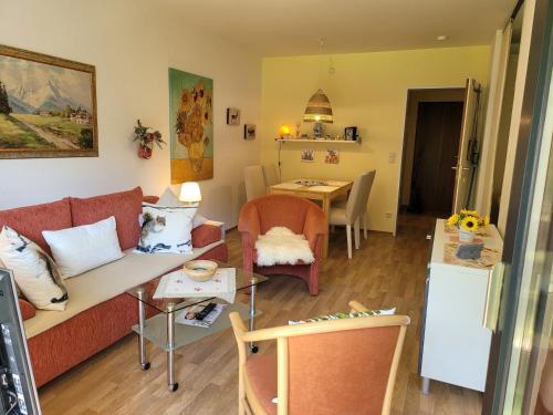 a living room with a couch and a table at Alpenschwänchen 2 - Salzschwänchen in Bad Reichenhall
