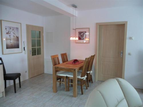 a dining room with a wooden table and chairs at Ferienwohnung Böcker in Oberwiesenthal