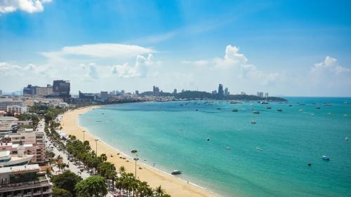 a view of a beach with boats in the water at Holiday Inn Pattaya by IHG in Pattaya Central