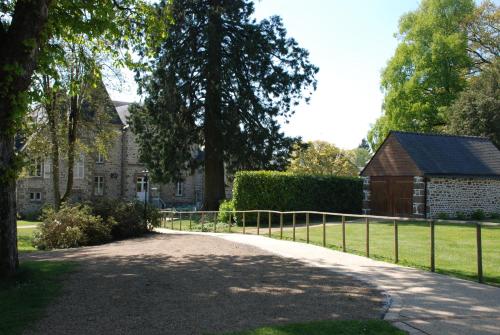 a path in front of a house with a fence at Château du Bourg in Saint-Denis-de-Gastines